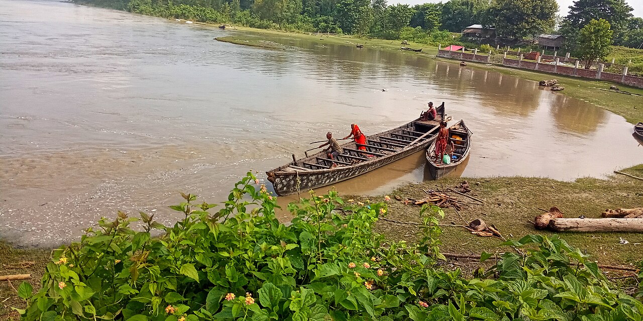 People gathering driftwood from the swollen Koshi river in Nepal