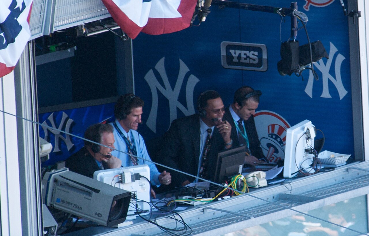 Commentators in a baseball broadcast booth
